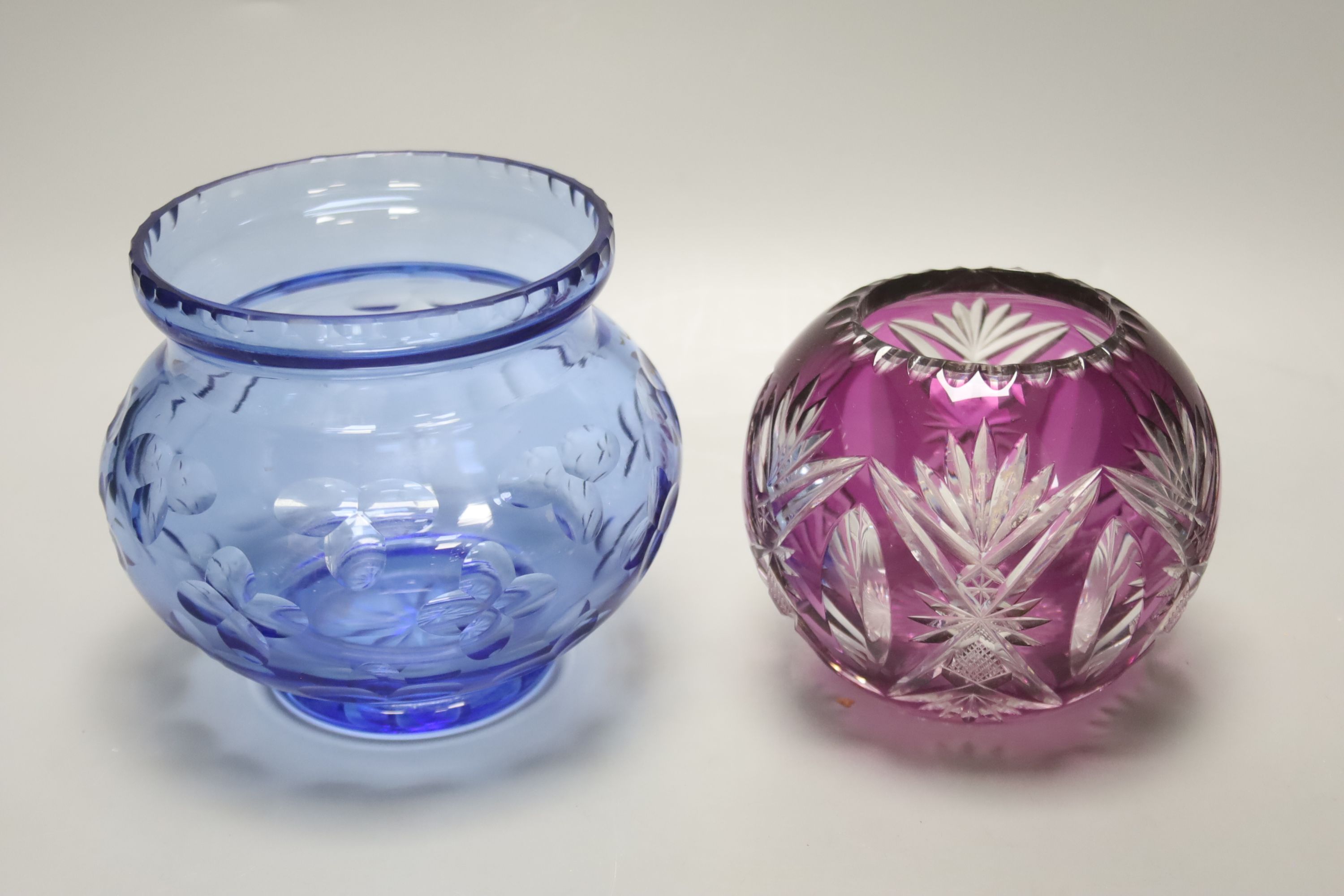 A group of coloured glassware including paperweights